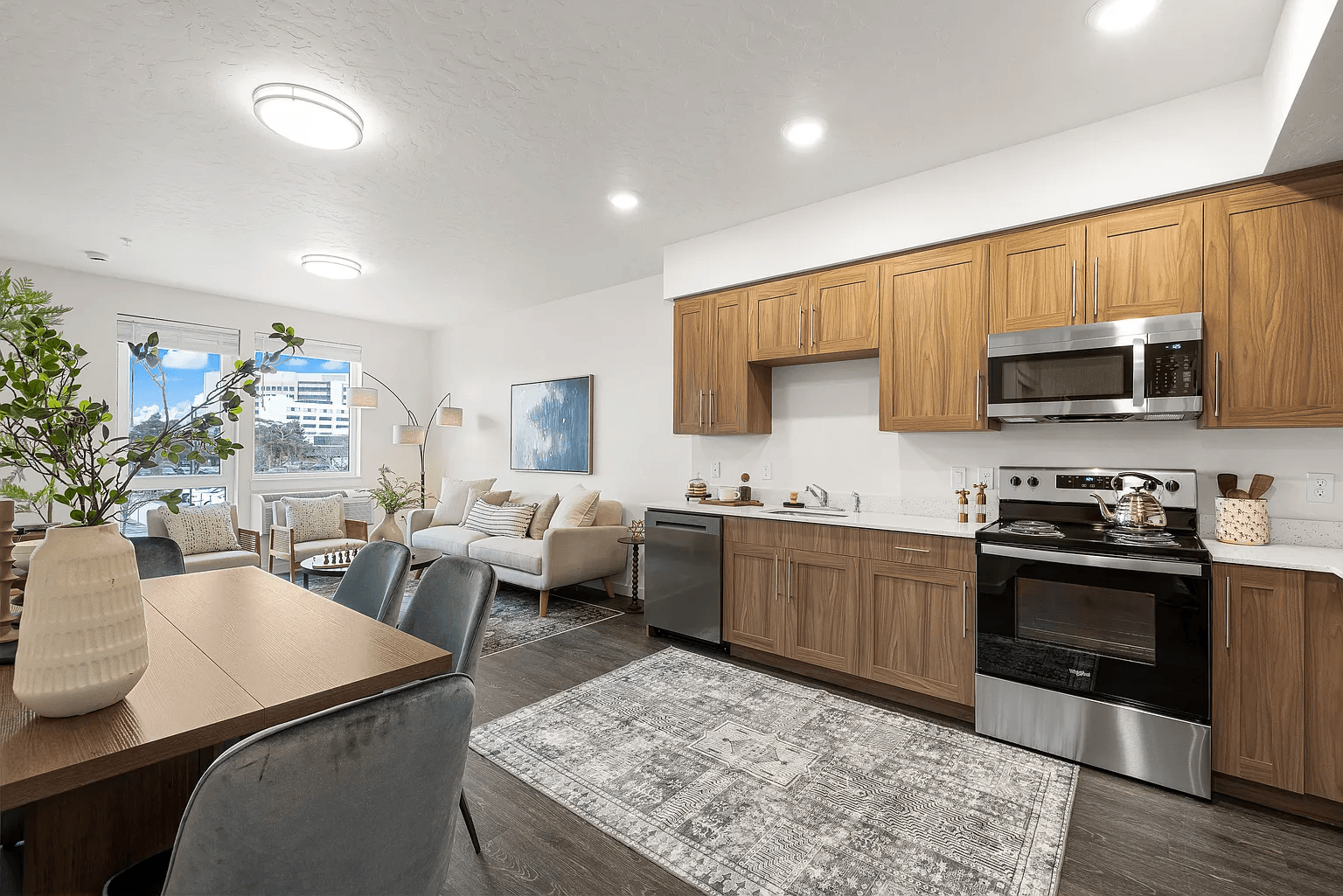 A modern kitchen with a dining table and chairs.